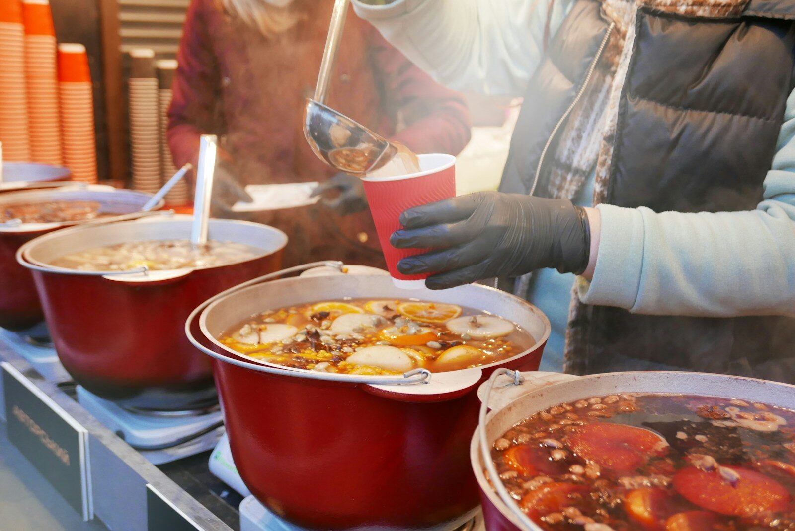 a person holding a spoon over a bowl of food